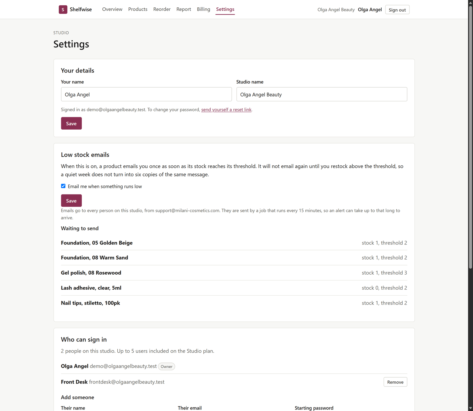 The Shelfwise settings page. Your details shows the name Olga Angel and the studio name Olga Angel Beauty with a Save button. Low stock emails has a checked box labelled Email me when something runs low, an explanation that a product emails once and stays quiet until you restock, and a Waiting to send list of five products with their stock and thresholds. Who can sign in shows two people, Olga Angel marked Owner and Front Desk with a Remove button, followed by an Add someone form.